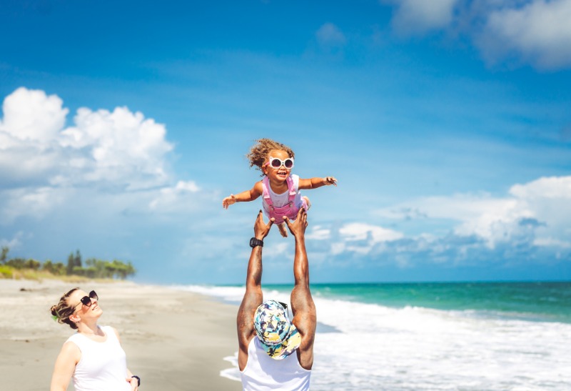 family playin on beach