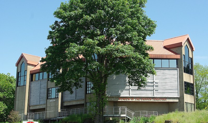 Museum of the Oregon Territory in Oregon City, Oregon, surrounded by mature trees.