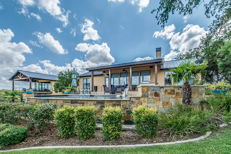 Stone wall around pool and back patio