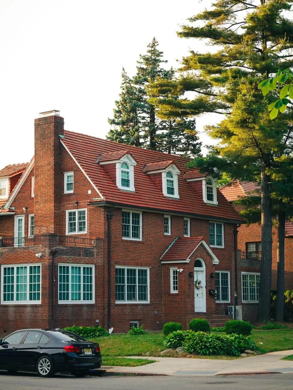 Sell my house fast in Queens — contemporary red-brick colonial home on a sunny Forest Hills street