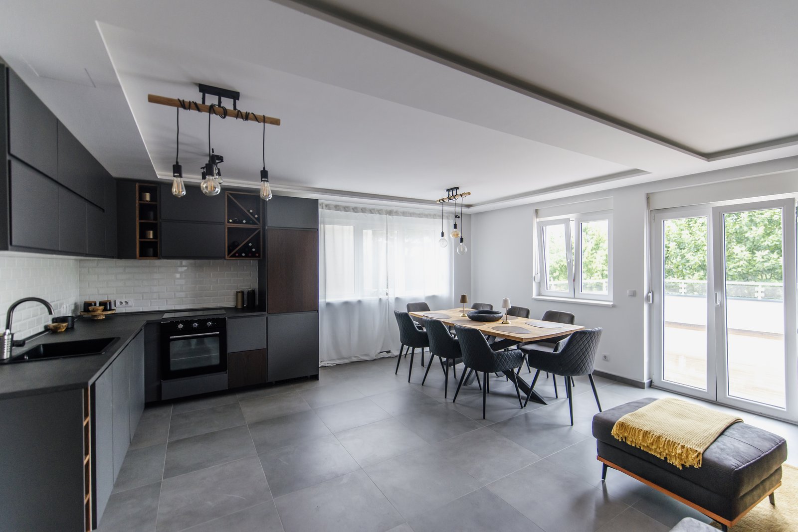 Bright modern open kitchen and dining room — updates like this can raise your home's value in Queens