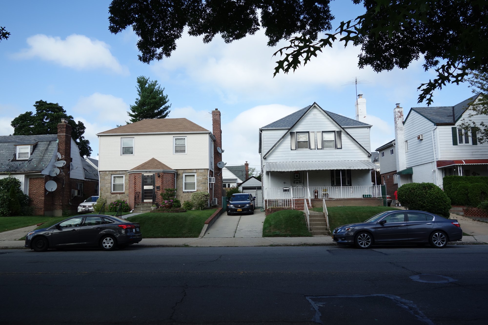 Well-kept single-family homes with front lawns on 188th Street in Fresh Meadows, Queens, NY