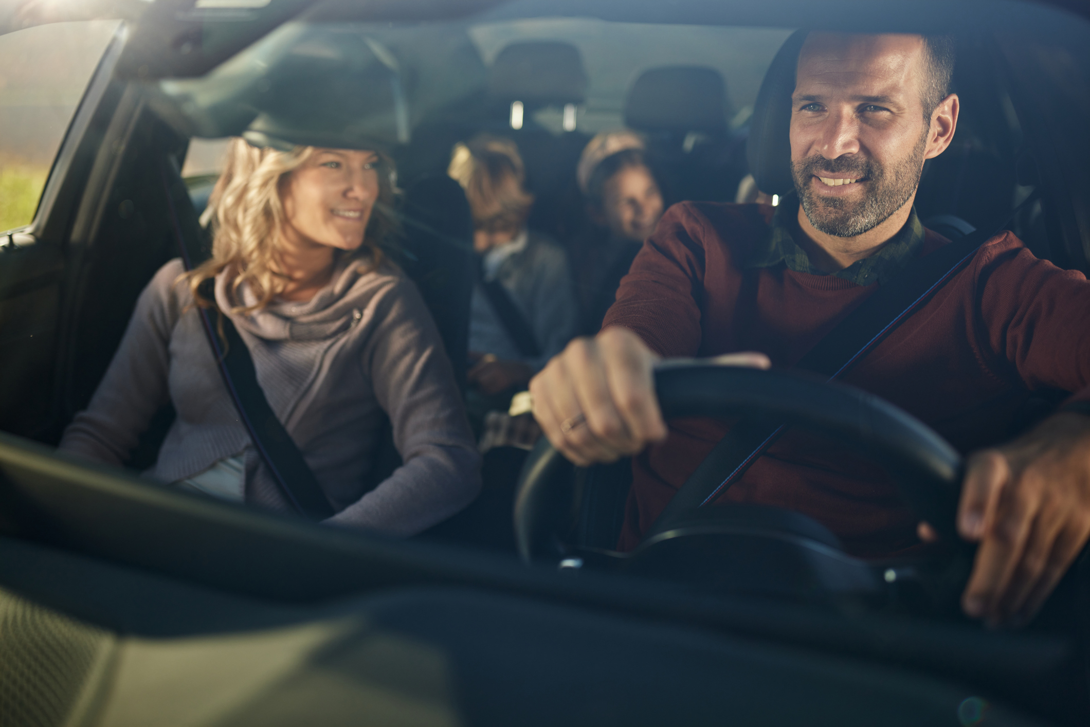 Family driving together in a car