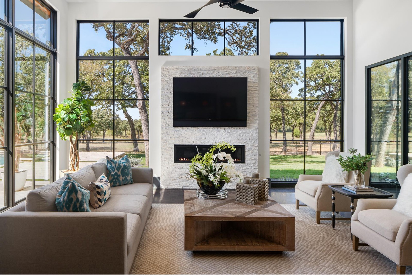 1200 Rockgate Road boasts three-sided walls of glass bringing the outside into the great room. (Photo courtesy of Zach Spross, for Douglas Elliman)