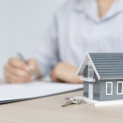 Refinancing Image with House and Person Signing Contract