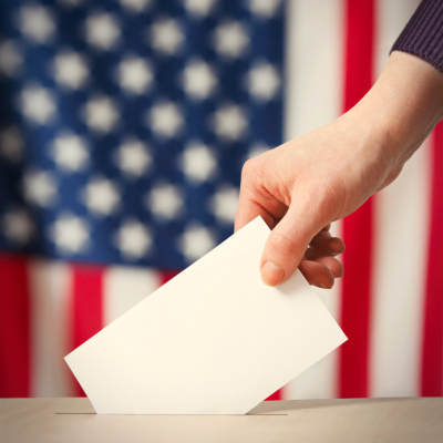 Election ballot being placed in box