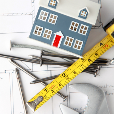 Architectural plans, nails, measuring tape, house, rebuilding