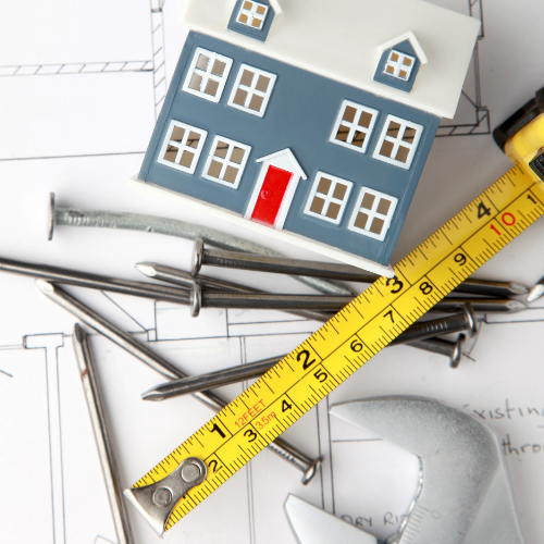 Architectural plans, nails, measuring tape, house, rebuilding