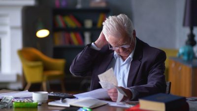 Business man stressed out from bill expenses