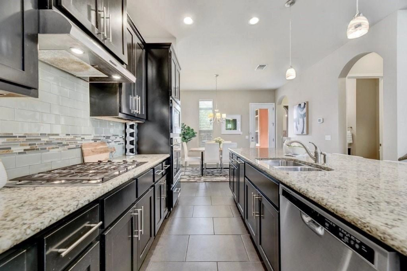 The kitchen features granite countertops and gas stovetop. What a delight, in such a well lit home. The kitchen features granite countertops and gas stovetop. What a delight, in such a well lit home.