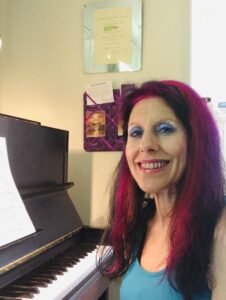 gfire sitting at a piano