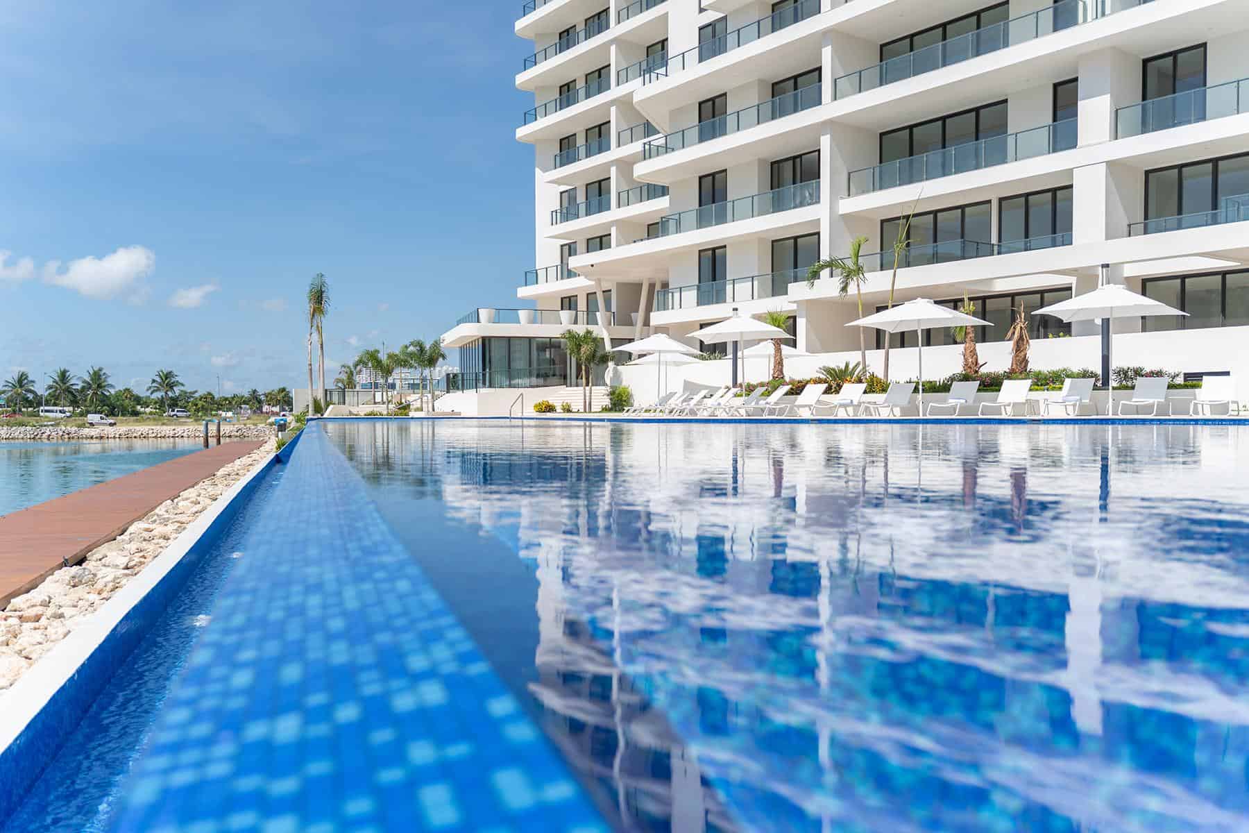 Pool overlooking the ocean at a luxury condo complex.