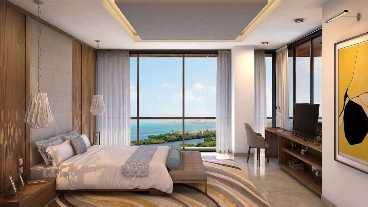 An oceanfront balcony view from a luxury penthouse condo overlooking the turquoise Caribbean Sea in the Riviera Maya.