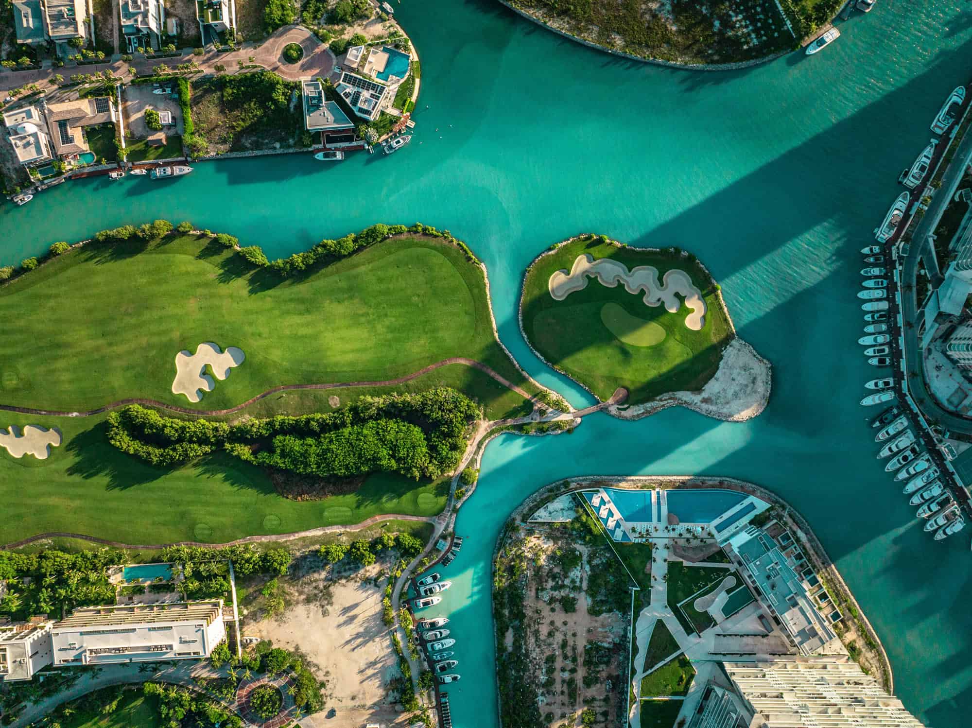 Aerial view of luxury beachfront lifestyle in Cancun featuring turquoise waters and modern architecture