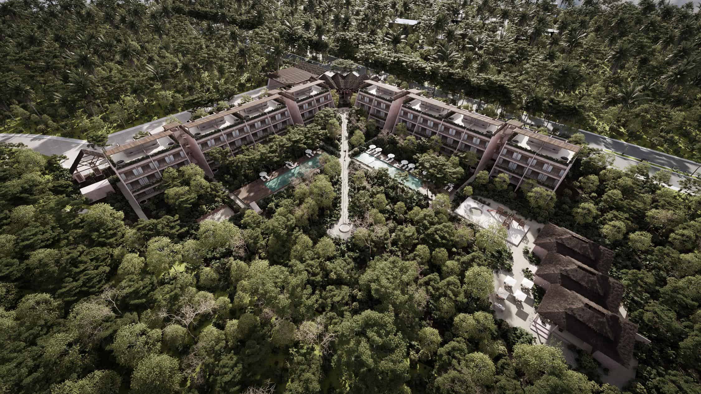 A secure, modern gated residential community entrance with 24/7 security guard infrastructure in the Riviera Maya.