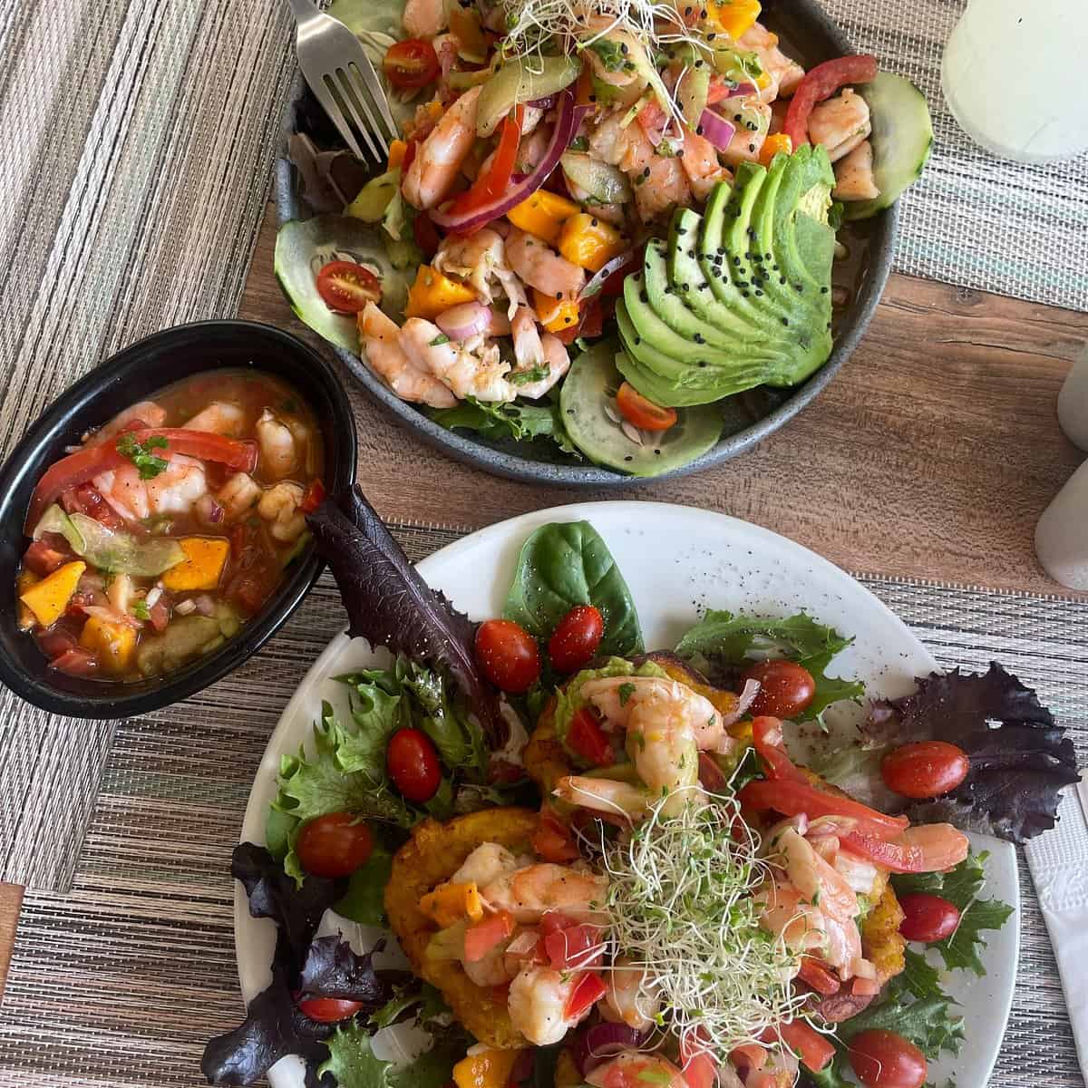 A close-up shot of a beautifully presented signature seafood dish from a top-rated Isla Mujeres fine culinary guide.