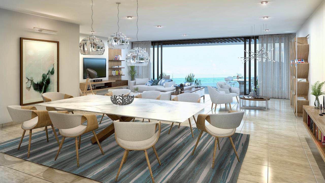 Spacious open-concept living room with floor-to-ceiling windows inside a luxury villa in the Riviera Maya.