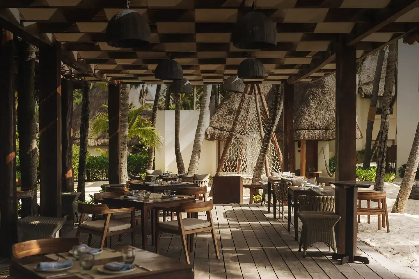 A modern high-end kitchen and open-concept dining area in a luxury Playa del Carmen villa.