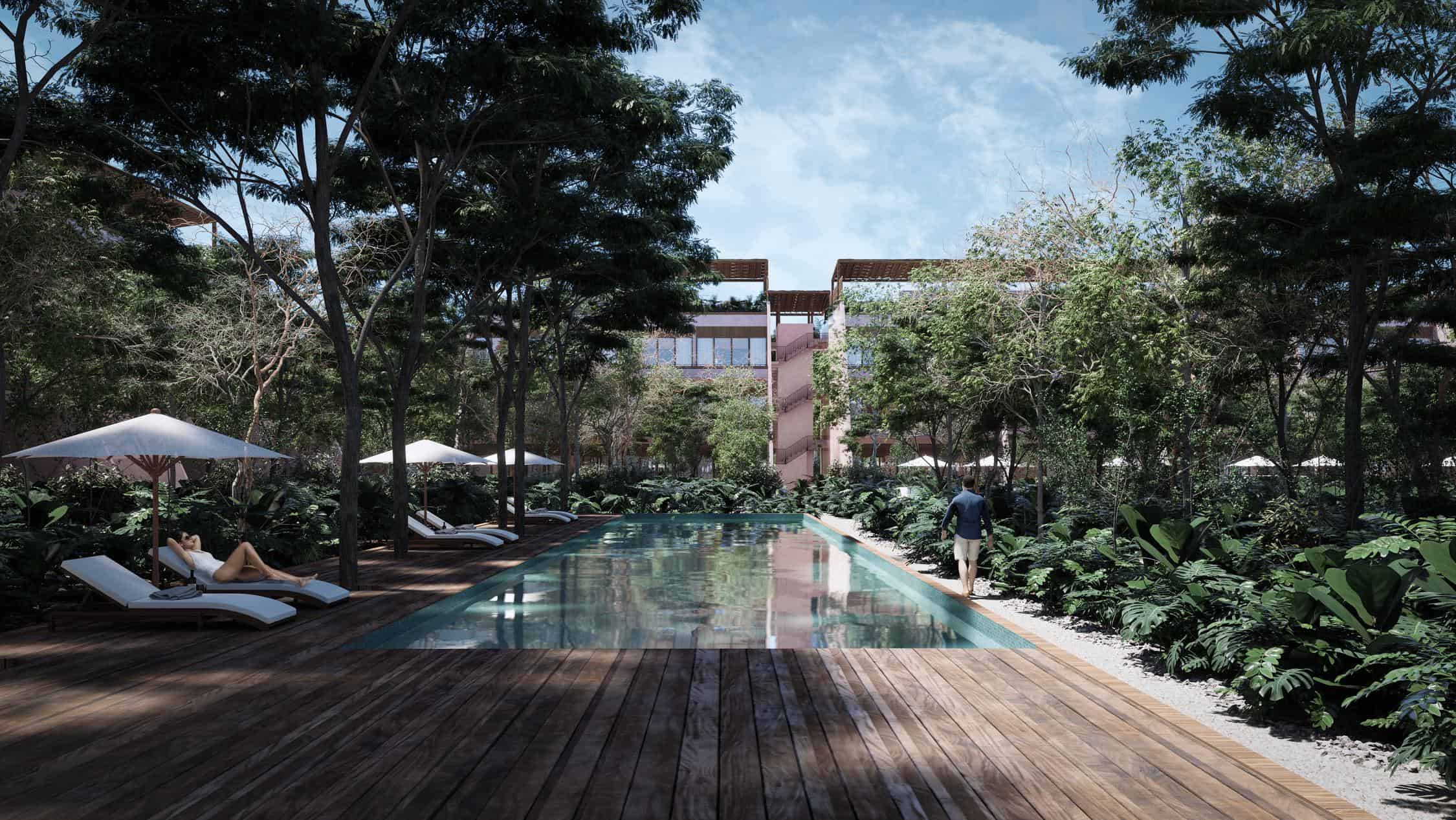 A modern luxury condominium development with a large resort-style swimming pool and tropical landscaping in the Riviera Maya.