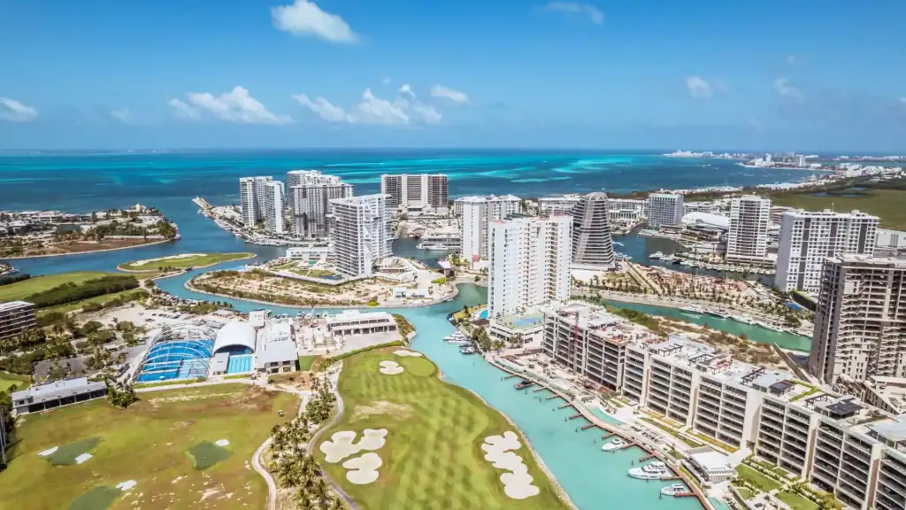 Panoramic view of luxury waterfront homes in Puerto Cancun residential marina.