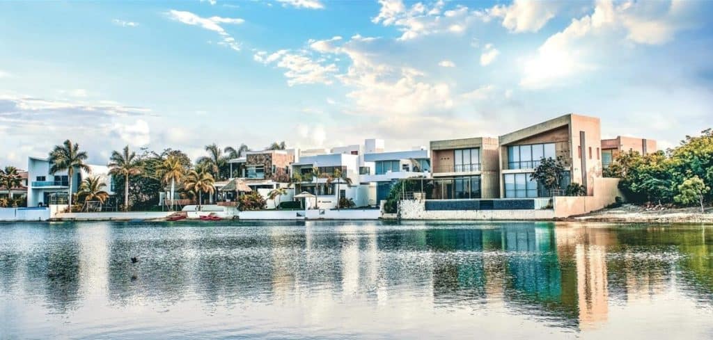 Aerial view of a luxury waterfront villa with tropical landscaping