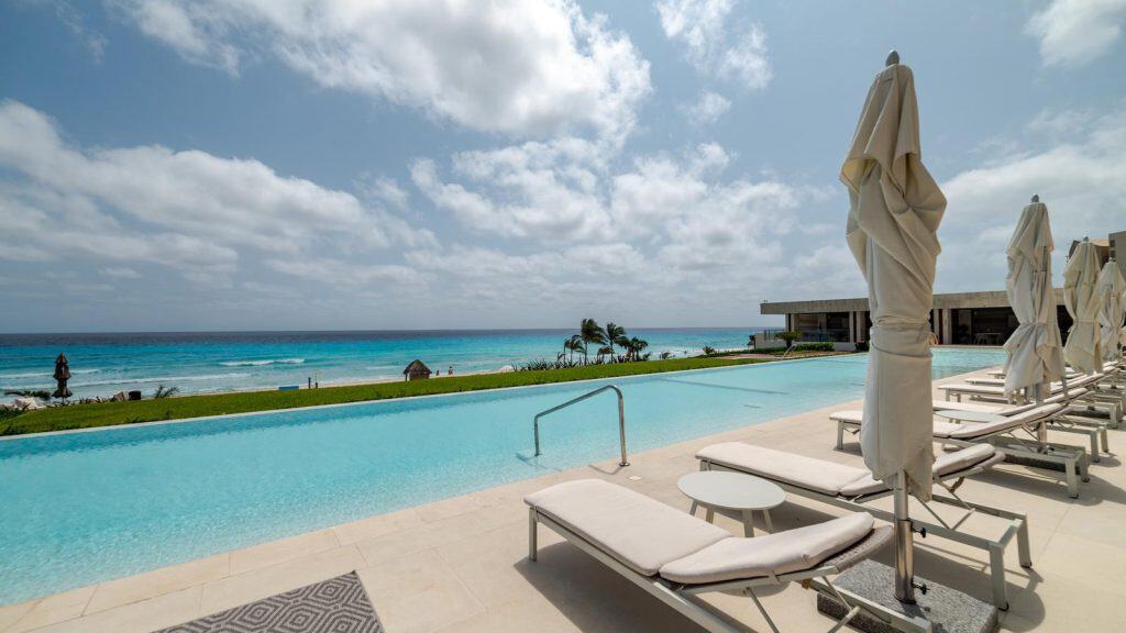 Secluded beachfront property terrace overlooking the turquoise waters of Cancun.