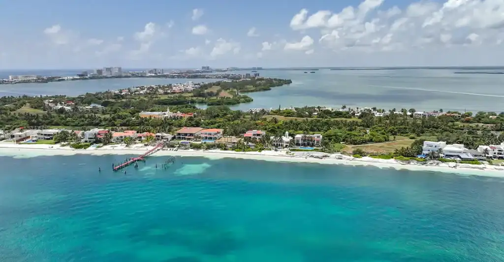 Modern contemporary oceanfront real estate listing on the coast of Cancun.