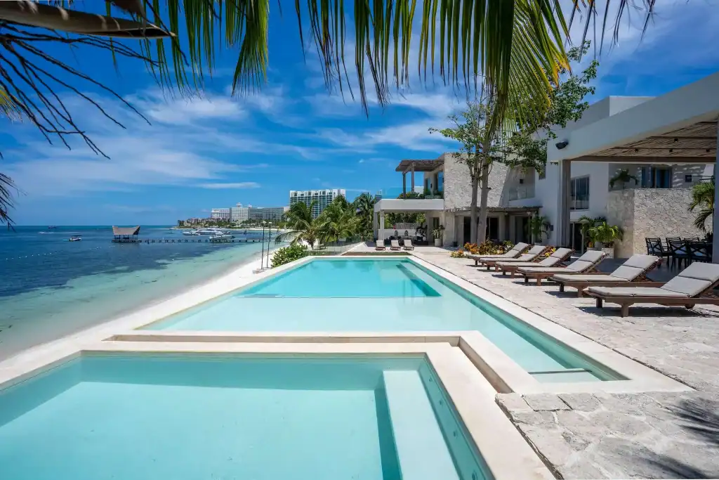Luxury beachfront villa for sale in Cancun with private infinity pool and ocean view.