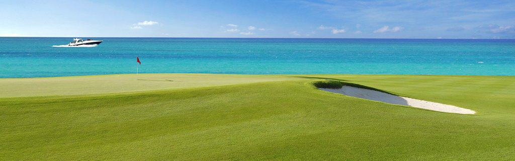 Golfer teeing off on a professional course in Cancun, Mexico