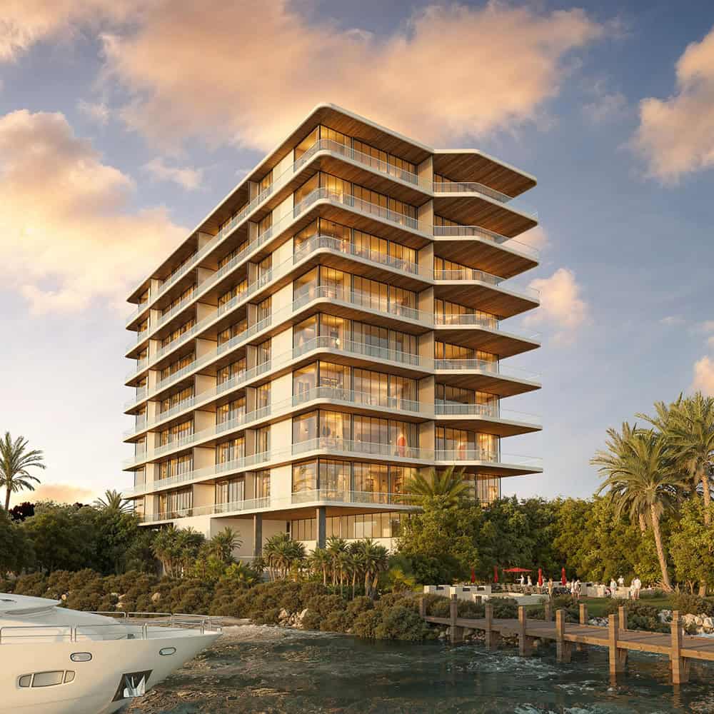 Exterior view of a modern apartment building in Cancun with a swimming pool, representing affordable condos for sale under 200k USD.