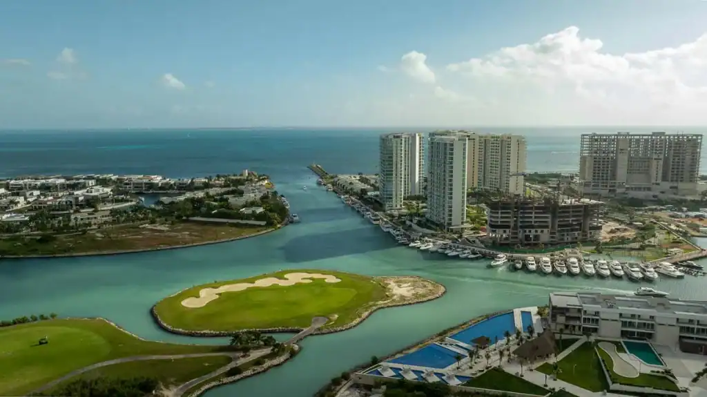 Homes in CancunSunset view of a modern luxury waterfront Puerto Cancun residences