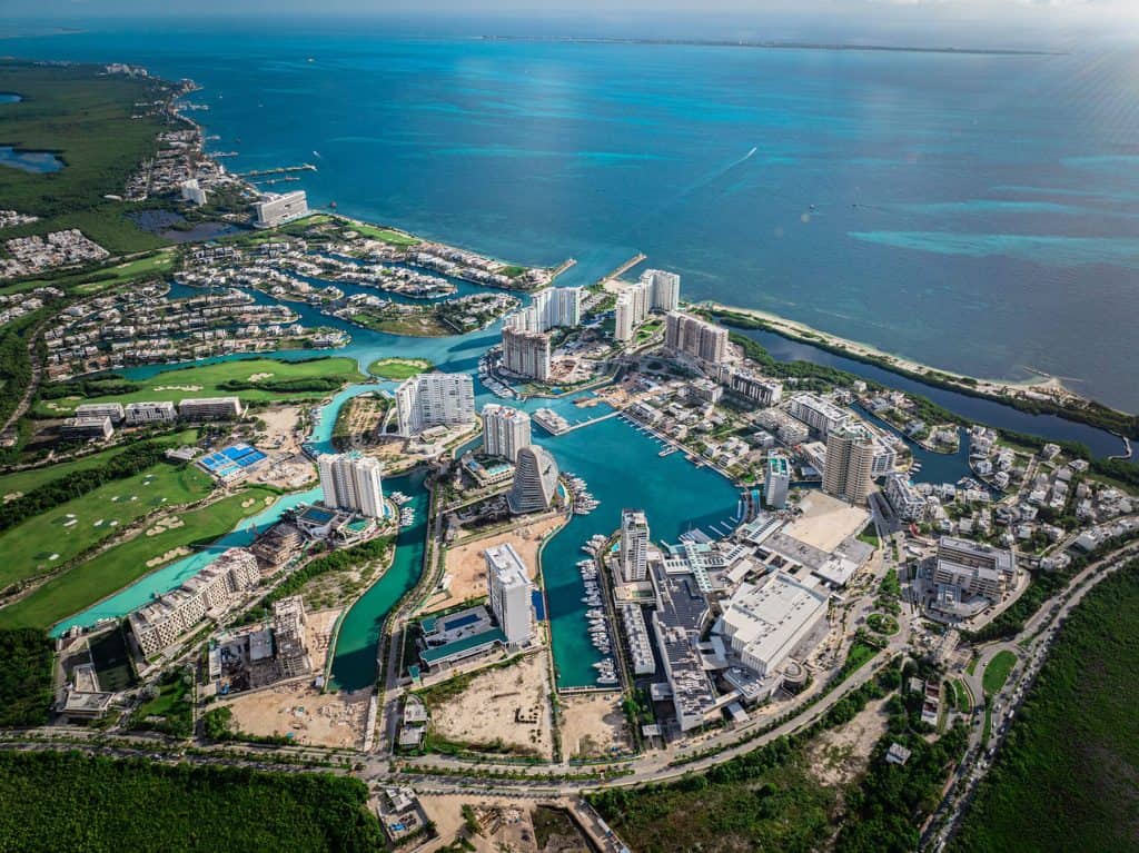 Panoramic view of a private dock and modern house in Puerto Cancun Marina
