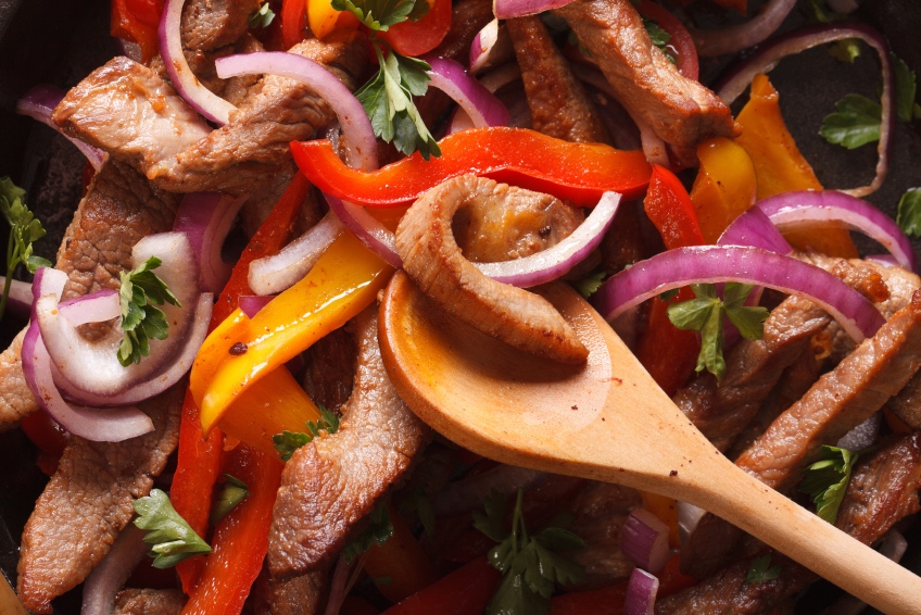 Cooking fajitas: beef with vegetables. macro vertical