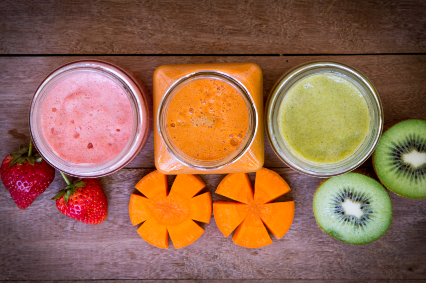 Top view of strawberry,kiwi and carrot juice blended on wooden b