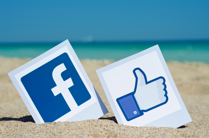 KIEV, UKRAINE - AUGUST 10, 2015: Facebook like logos for e-business, web sites, mobile applications, banners, printed on paper and placed in the sand against the sea Social network facebook sign.