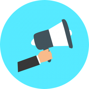 Image is a drawing of a hand holding a megaphone within a blue circle.