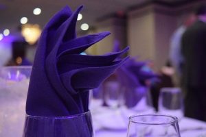 Image is a close up of a table setting at a fancy dinner party.