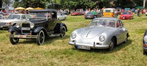 Image is of classic cars in an outdoor car show. Image is of classic cars in an outdoor car show.