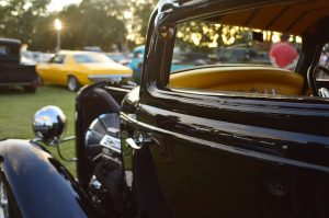 Image is a close up of a classic car at an outdoor car show.