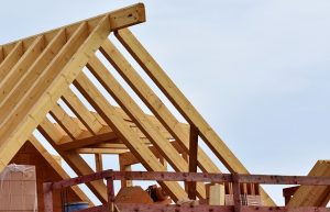 Image is roof trusses on a home under construction.