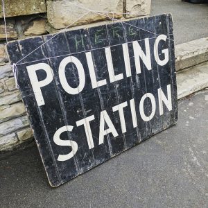 Image is of a sign that reads "polling station."
