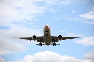 Image is of an airplane getting ready to land, taken from the ground.