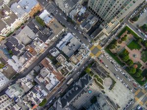 image is the view of an urban center from the vantage point of a drone.