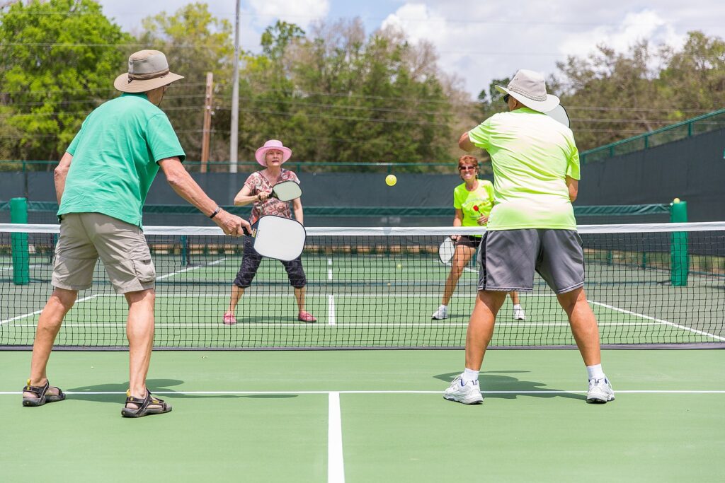 Pickleball players. Image from TheVillagesFL, CC BY-SA 4.0 <https://creativecommons.org/licenses/by-sa/4.0>, via Wikimedia Commons