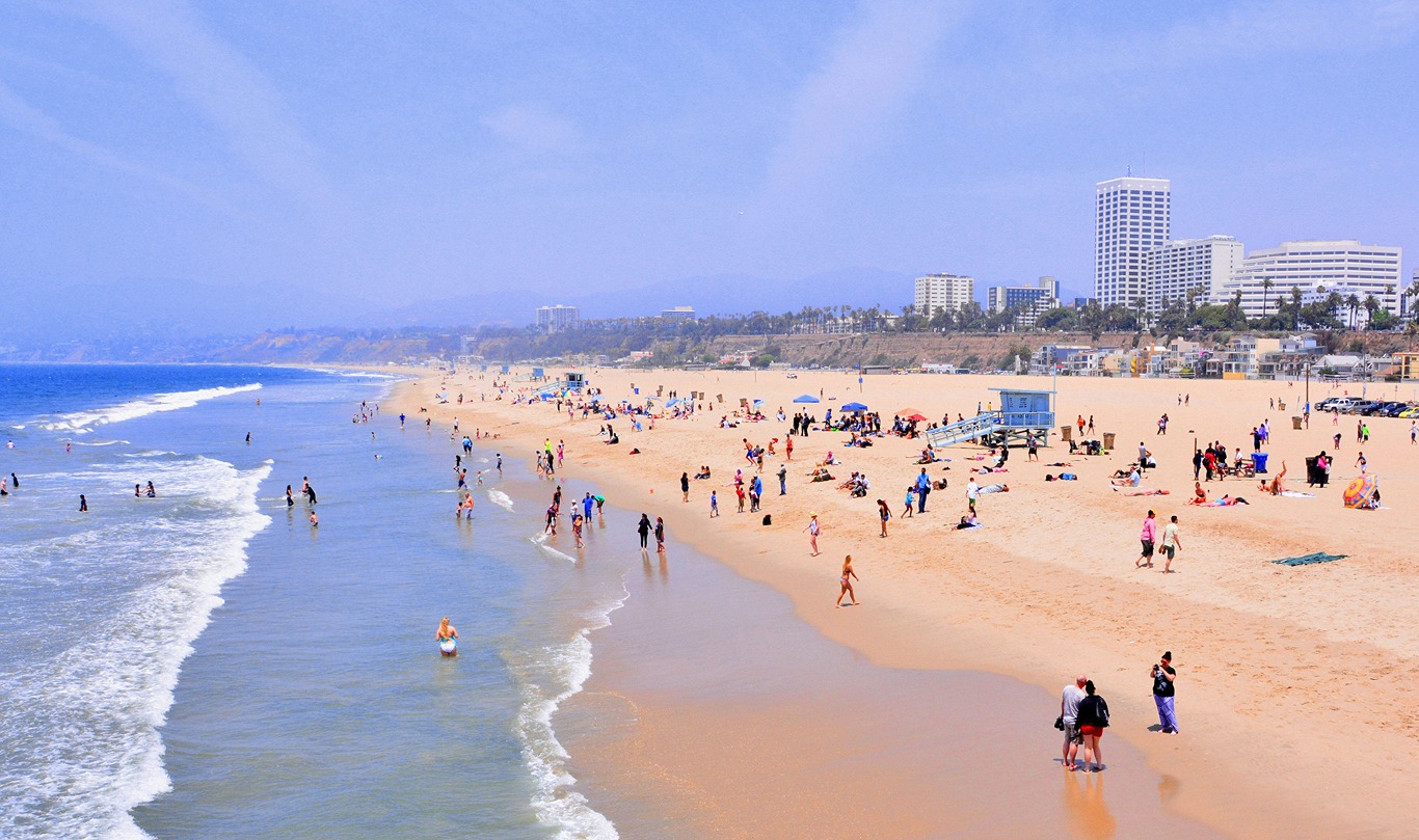 Santa Monica beach with blue sky and people.