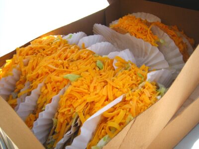 Tito's Tacos with cheese, lettuce, and beef are a mainstay of Tito's Taco and Vodka Day.