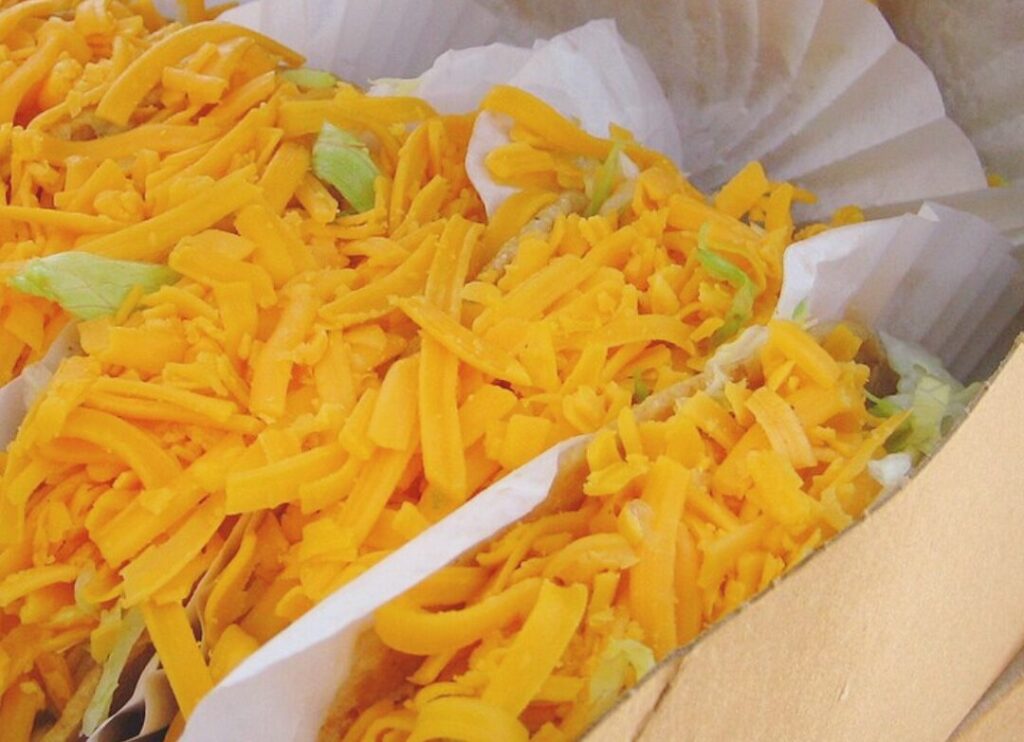 Tito's Tacos with cheese, lettuce, and beef are a mainstay of Tito's Taco and Vodka Day.