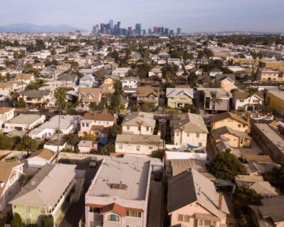 An image of several Los Angeles homes with the city skyline in the distance.