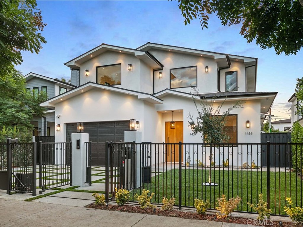 Gated modern front exterior of 4437 Calhoun Avenue in Sherman Oaks at dusk