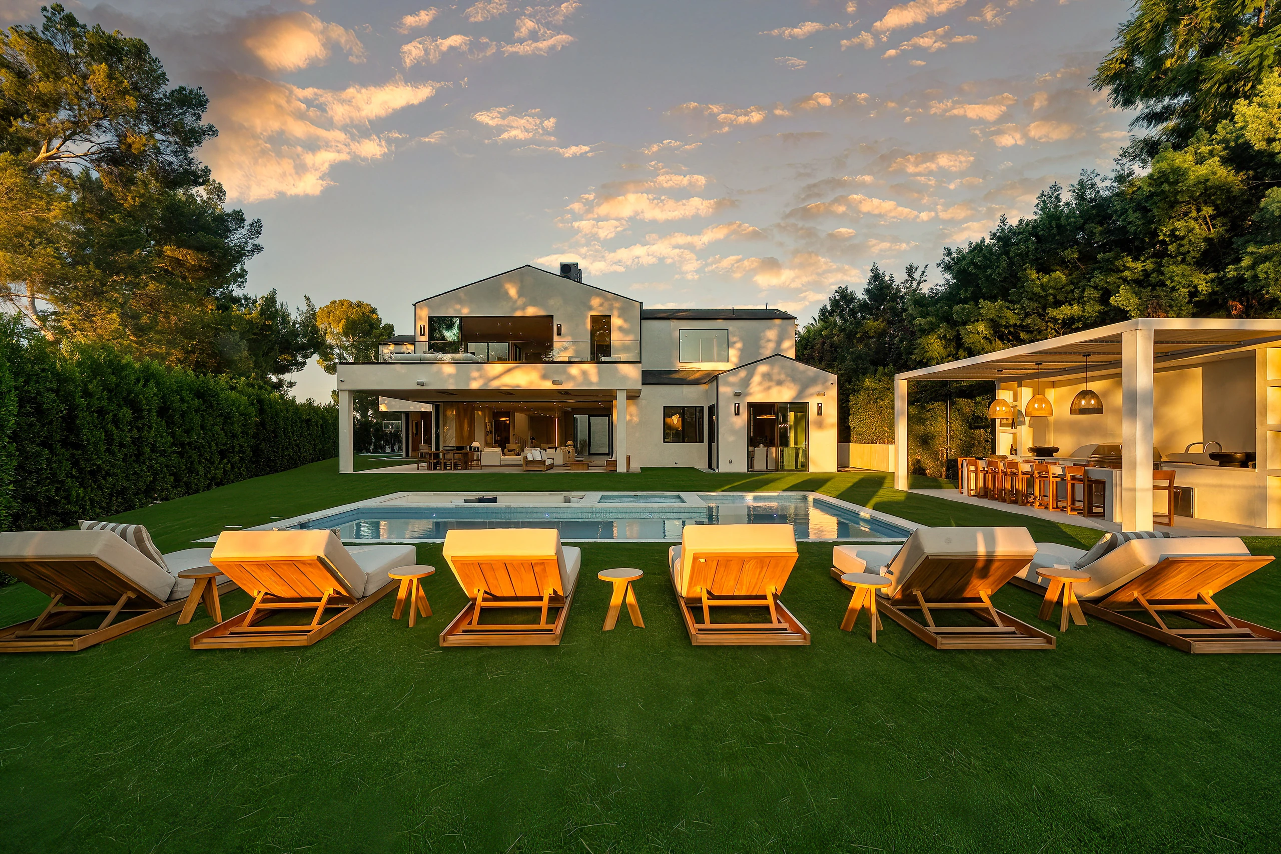 The pool, lawn and illuminated outdoor pavilion at Royal Oak